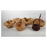 Group of baskets, mostly buttocks baskets, one