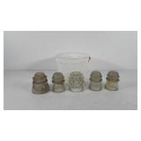 Bucket of five glass insulators