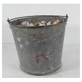 Galvanized bucket full of seashells