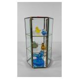 Brass and glass hexagon curio cabinet with art