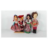 Four dolls dressed in costume, one marked made in