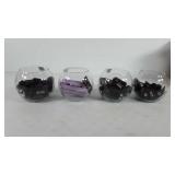 Four glass bowls full of lipsticks