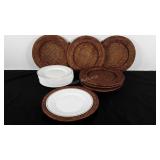 Seven wicker chargers and stack of disposable