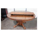Oval table with glass topper and two 11" leaves,