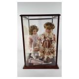 Porcelain dolls, two porcelain dolls in display