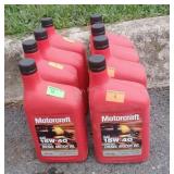 Eight partial jugs of 15w-40 diesel motor oil