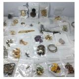 Jewelry in tin container, pendants, earrings,