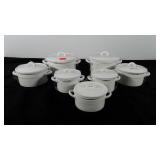 Seven porcelain ovenware dishes in various sizes,