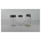 Three glass jars, with zinc tops and milk glass
