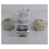 Group of four porcelain trinket/music boxes,