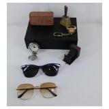 Two pairs of sunglasses, pencil sharpener,