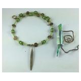 Green beaded necklace and a brooch
