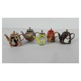Five miniature teapots, two have hinged lids and