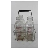 Four Farm Fresh glass milk bottles in wire bottle