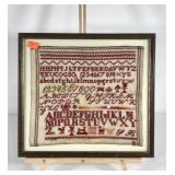 Early needlework sampler, signed YB, framed under