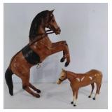 Two horse figures, one plastic the other