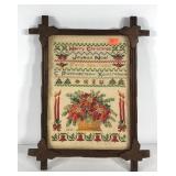 Holiday needlework sampler in Adirondack frame,