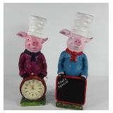 Two poly resin piggy statues, one with clock and
