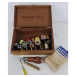 Wooden cigar box with spools of thread,