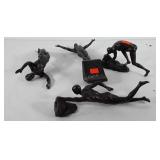 Four wall hanging gymnast sculptures