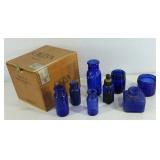 Group of old blue glass bottles, some marked as