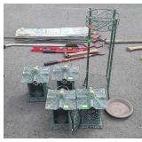 Four cast iron candle holders and plant stand