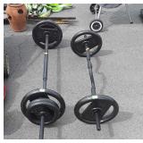 Curl bar with 25 pound weights and bench press