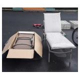 Two patio lounge chairs, one is still new in the