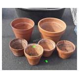 Group of five terracotta flower pots and one
