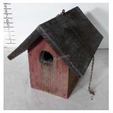 Rustic birdhouse from rough cut boards.