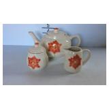 Three piece teapot set with teapot, sugar, and