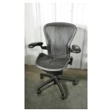Adjustable desk chair with mesh back and bottom.