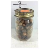Jar of marbles, some are wooden