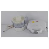 Two small electric appliances, juicer and waffle