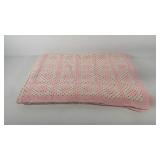 Pink and white crocheted throw blanket, some