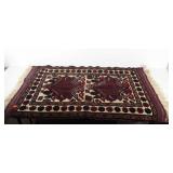 Small woven rug with fringed edges, 56" × 32"
