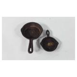 Two small cast iron skillets, one marked Atlanta