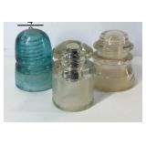 Three glass insulators , one is marked Whitehall