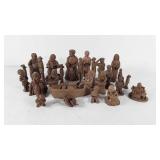 Twenty-eight unpainted clay figurines, artist