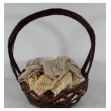 Basket of large crocheted dollies and table runner