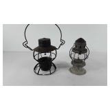 Two oil lanterns, one is missing glass, one has