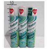 Three cans of Batiste dry shampoo
