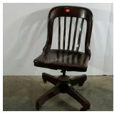 Wooden office chair, finish is peeling as shown