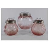 Pink Depression Glass vases with metal frog lids