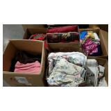 Skid lot includes clothes, linens, pillows, and