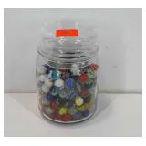 Glass jar full of marbles, 6" × 4"