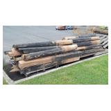 Huge pile of wood half round fence posts, little