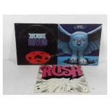 Three Rush vinyl records, Rush, Fly By Night, and
