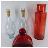 Four oversized decorative glass bottles