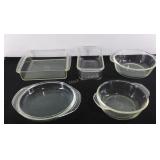 Four glass baking dishes and a lid to a